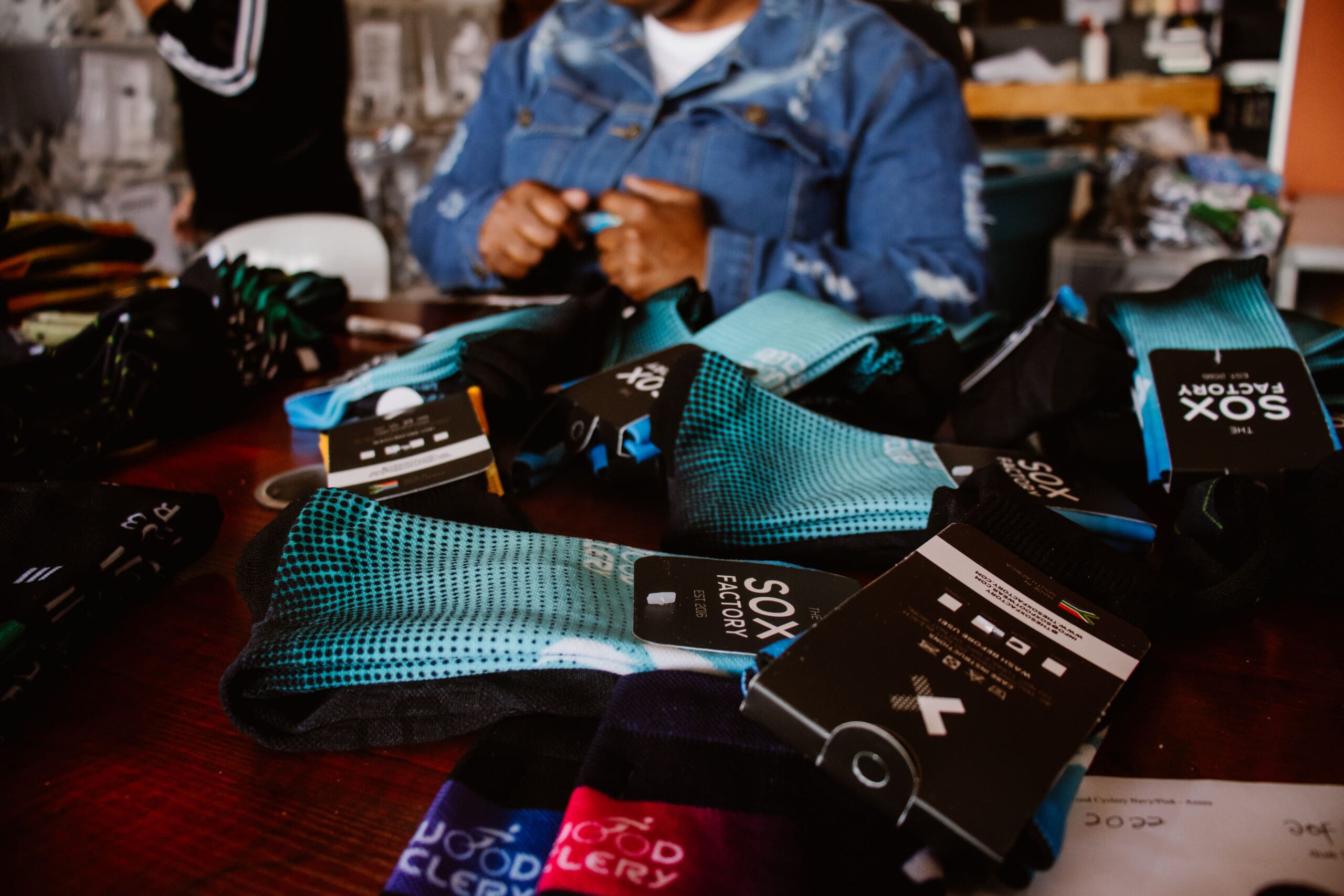 A heap of finished and tagged custom socks, symbolizing the growth and production success of The Sox Factory from 2016 to 2024.